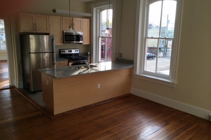 Interior view of kitchen from front living space of 801-803 N 23rd Street with low light