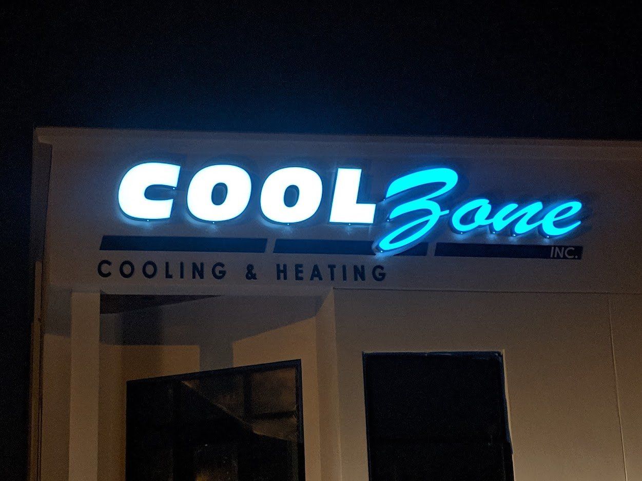 A cool zone sign is lit up at night