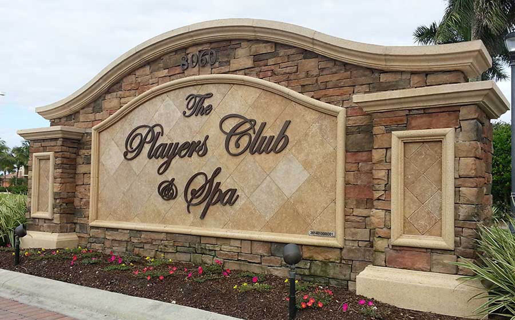 A stone monument sign for The Players Club & Spa.