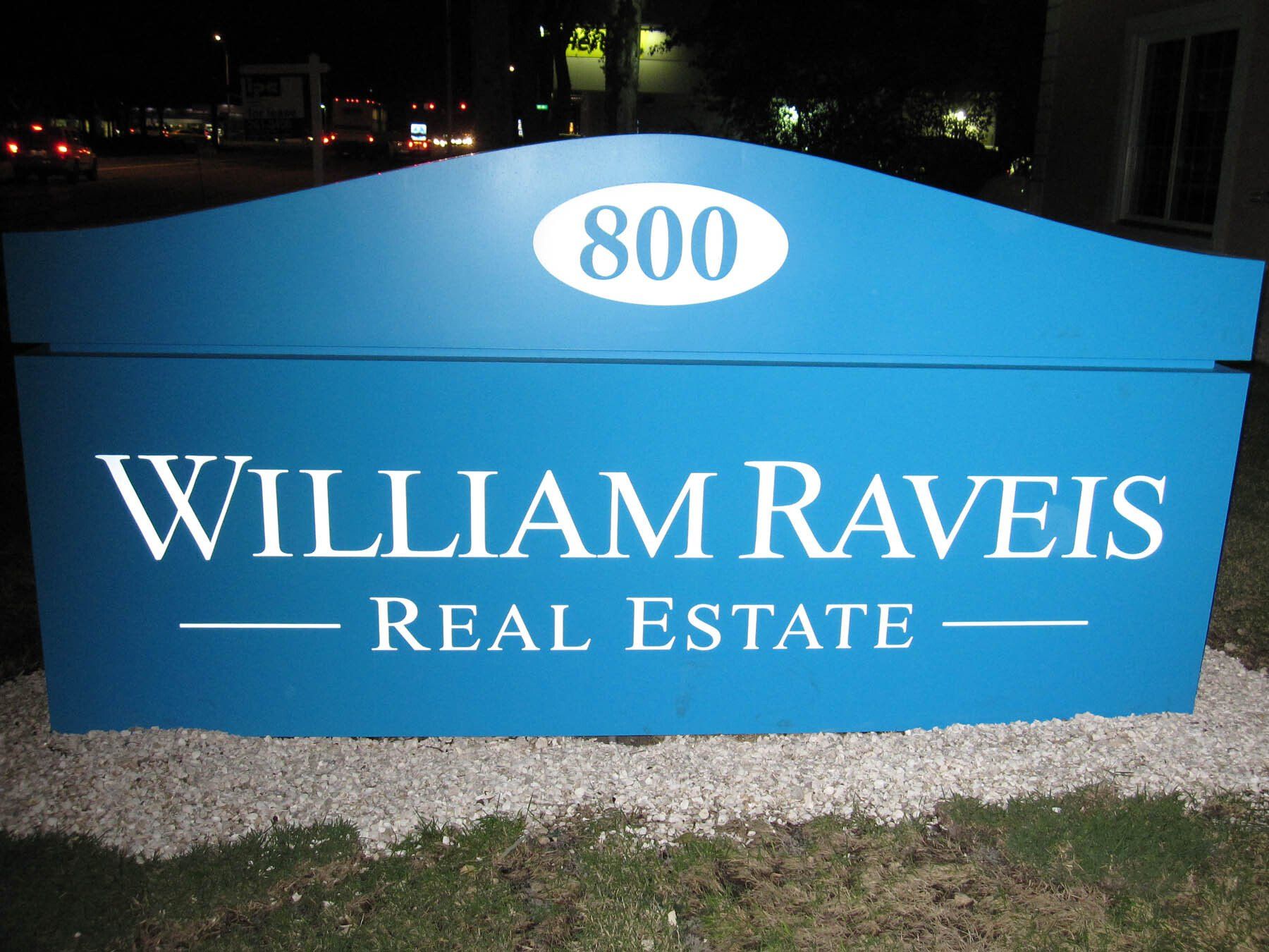 An internally lit blue monument sign for William Raveis.
