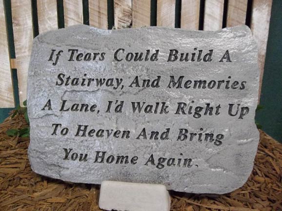 A stone with a quote on it that says if tears could build a stairway and memories a lane