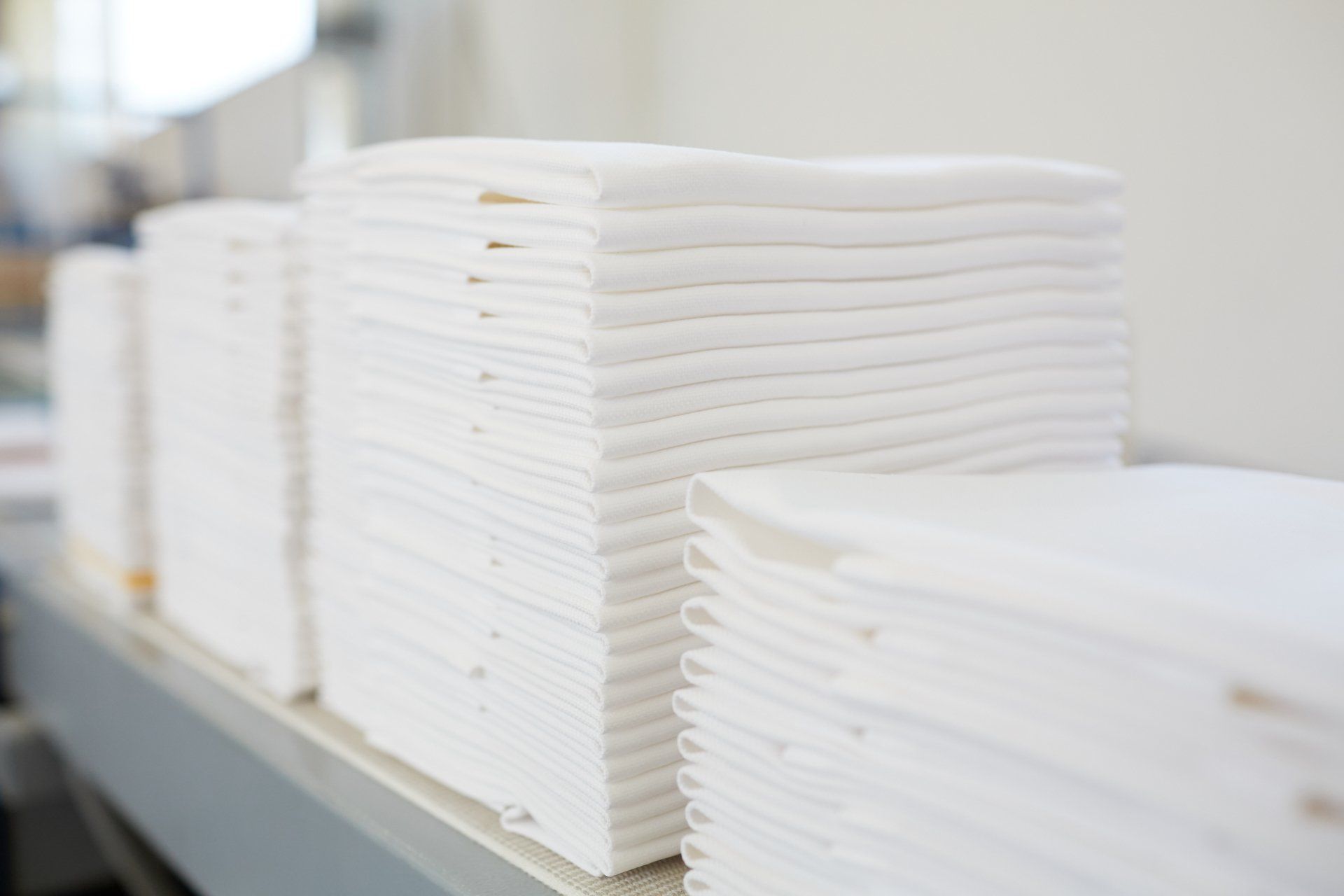 picture of freshly pressed bedding, folded and stacked