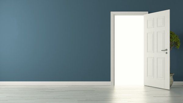 Opened American door with blue wall and reflective floor