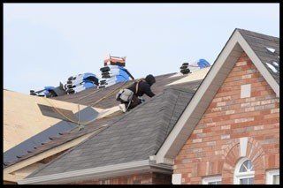 roofing contractors repairing a roof