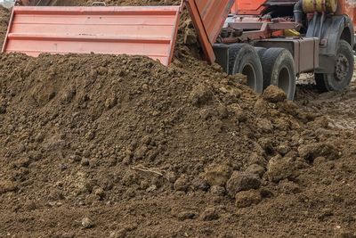 Landscapers — Dump Truck Dumping Dirt in San Antonio, TX Landscapers — Dump Truck Dumping Dirt in San Antonio, TX