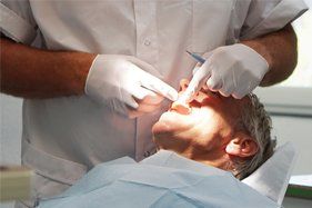 man being looked at by a dentist