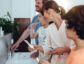 family brushing their teeth