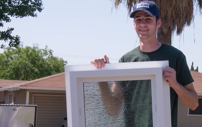 Window Replacement — Man Installing Window in Fresno, CA Window Replacement — Man Installing Window in Fresno, CA