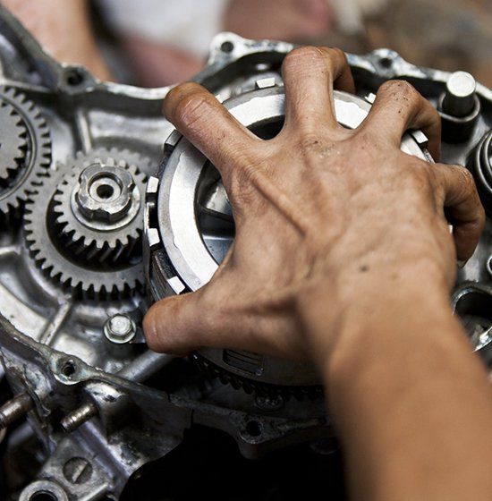 Hand Grabbing a Motorcycle Part — Motorbike Repairs in Lismore, NSW