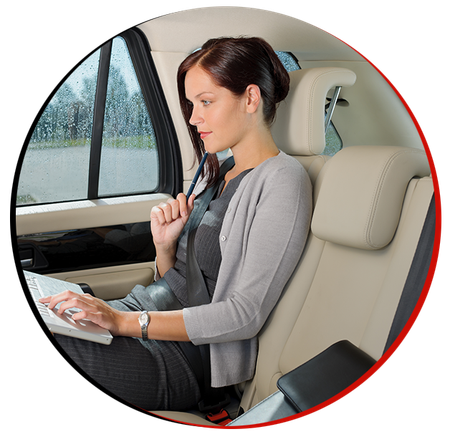 woman sitting in the car and working on the laptop