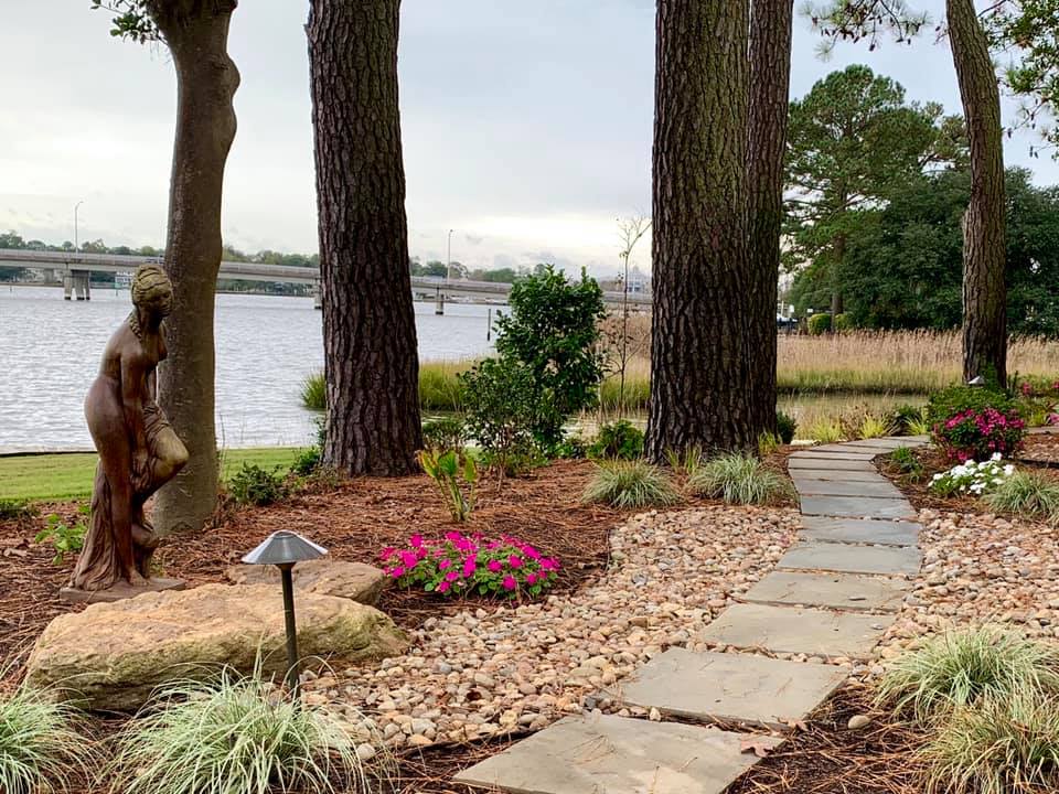 Female Statue Next To Flowers And Tall Trees — Virginia Beach, VA — Gentle Rain