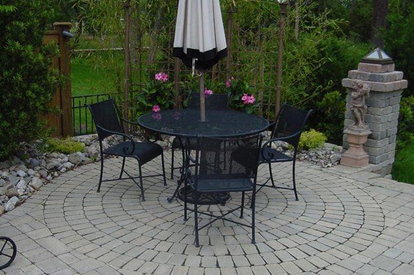 Outdoor Seating Area With Black Seats And Black And White Closed Umbrella — Virginia Beach, VA — Gentle Rain