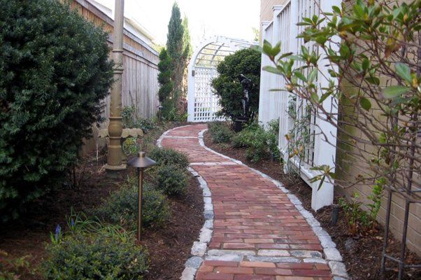 Stone Walkway Next To Nice White Structures And Bushes — Virginia Beach, VA — Gentle Rain