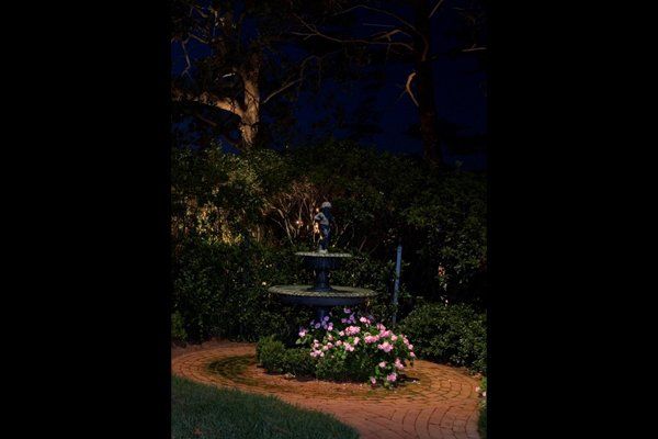 Water Fountain Next To Flowers With Nice Landscaped Lighting — Virginia Beach, VA — Gentle Rain