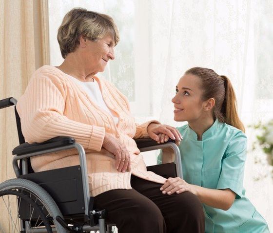 home health aide and patient smiling