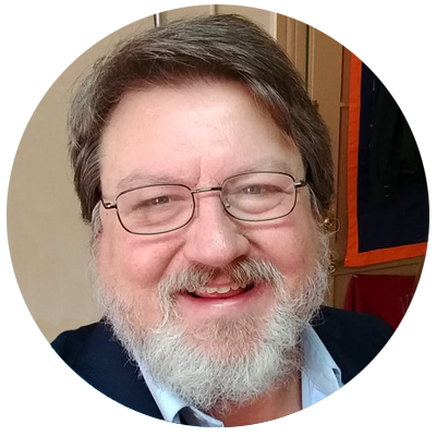 Jeff Bishop, White man with brown hair, white beard wearing glasses and a navy blue jacket
