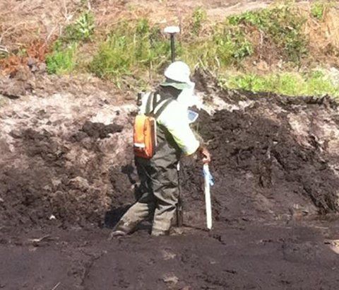 Worker Doing Topography Survey | Aiken, SC | Tripp Land Surveying, Inc. Worker Doing Topography Survey | Aiken, SC | Tripp Land Surveying, Inc.