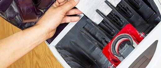 Installing Clean Air Filter in Vacuum — Vacuum Center in Seattle, WA Installing Clean Air Filter in Vacuum — Vacuum Center in Seattle, WA