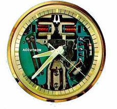 Vintage Accutron watch face with exposed internal mechanism and gold rim