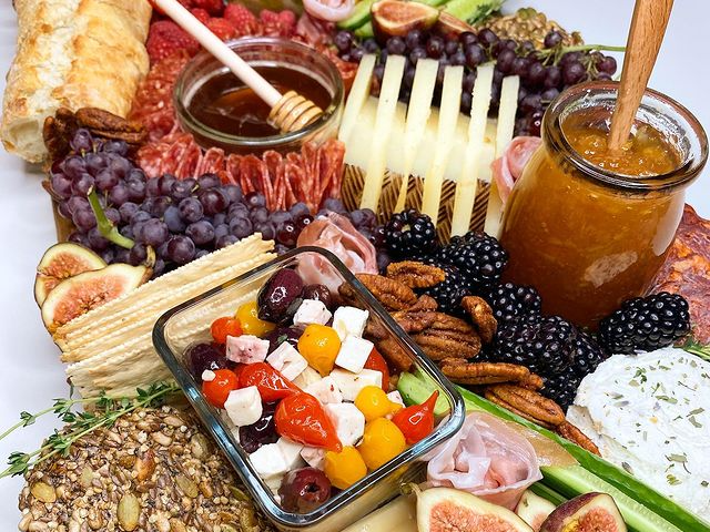 A plate of food with a jar of honey on top of it.