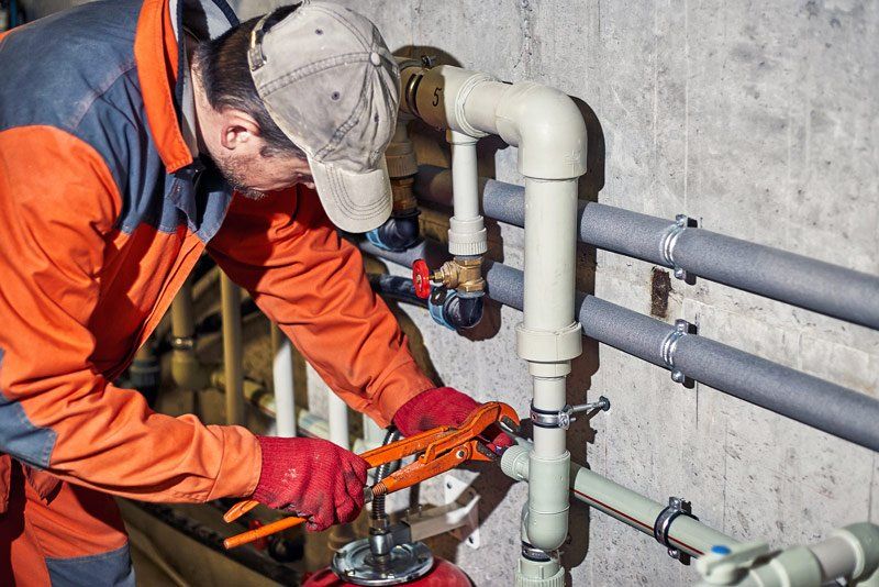 Plumber Repairing Pipes — Hopewell, PA — Mark A. Redinger Plumbing and Heating Inc. Plumber Repairing Pipes — Hopewell, PA — Mark A. Redinger Plumbing and Heating Inc.