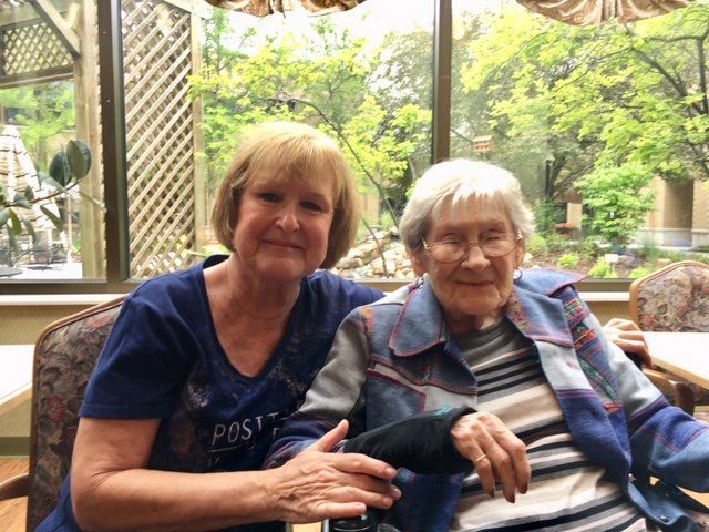 Mother enjoying visit by daughter in the Garden Room. Mother enjoying visit by daughter in the Garden Room.