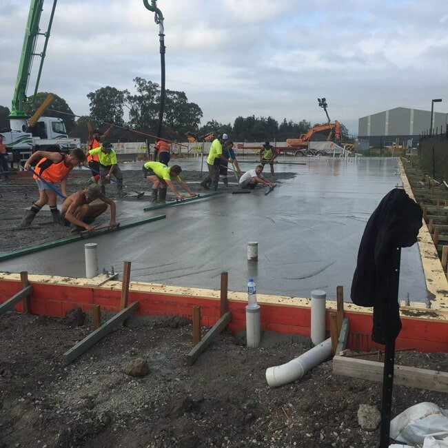 Workers Levelling Concrete — Concreting in Tanilba Bay, NSW Workers Levelling Concrete — Concreting in Tanilba Bay, NSW