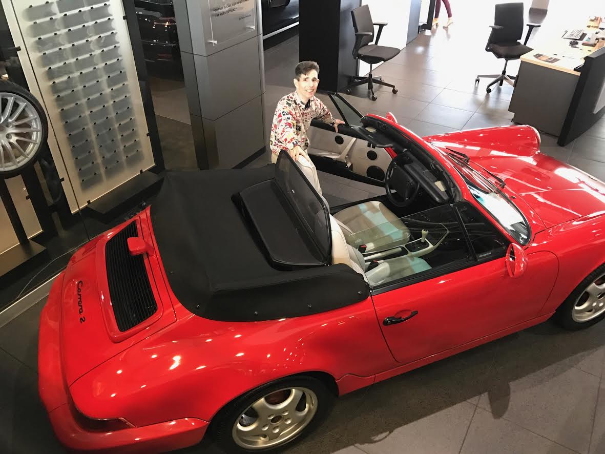 With a red Porsche at my friend's dealership.