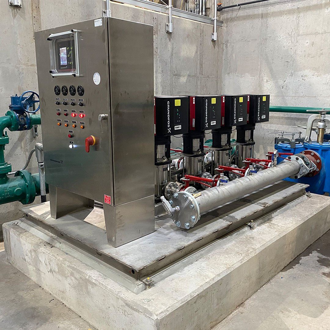 A stainless steel machine is sitting on top of a concrete platform.
