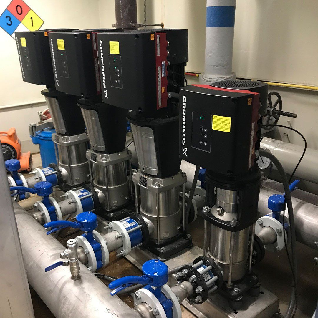 A bunch of pumps are sitting next to each other in a room.