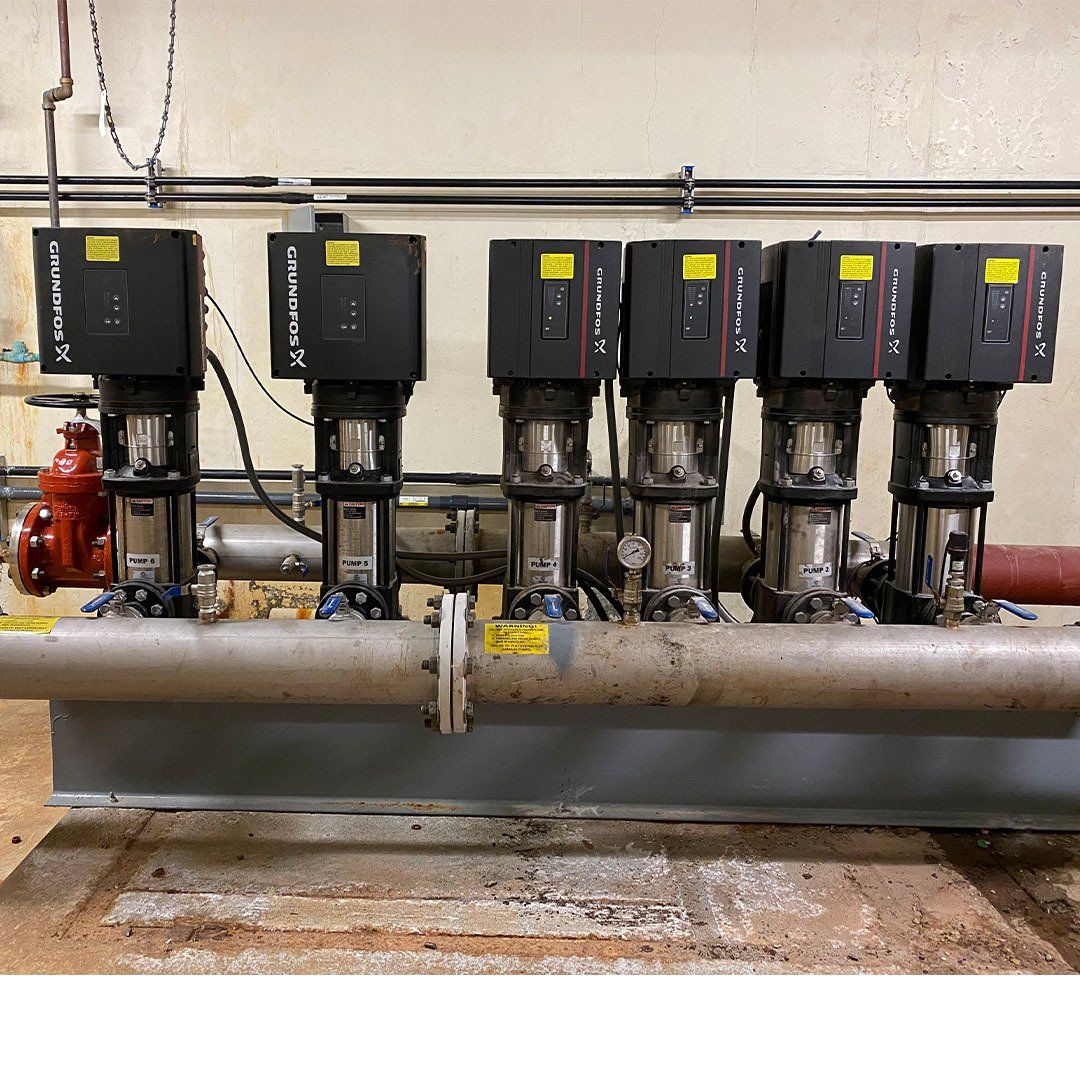A bunch of pumps are lined up next to each other and one of them says ' nsf ' on it