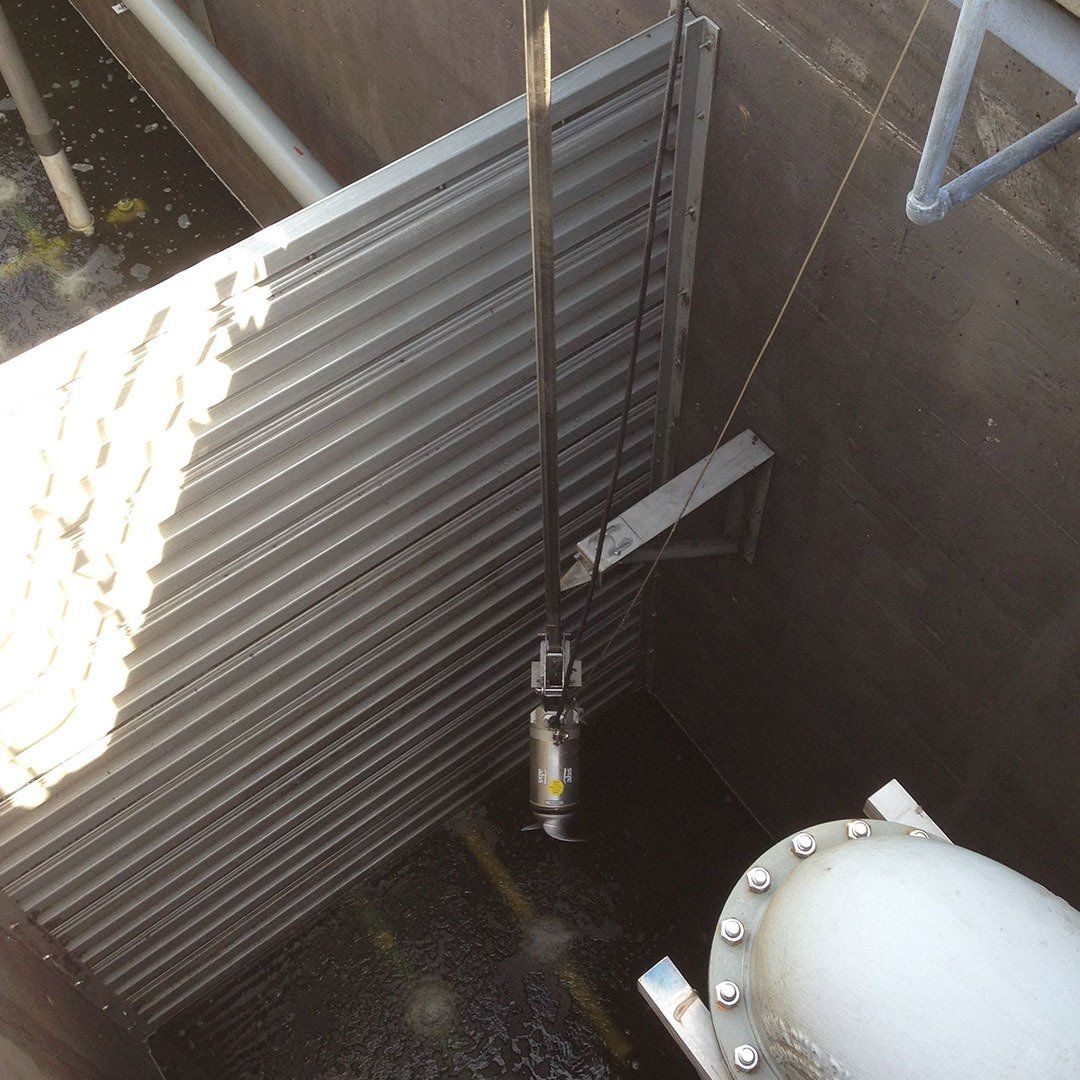 A metal pipe is attached to a metal wall