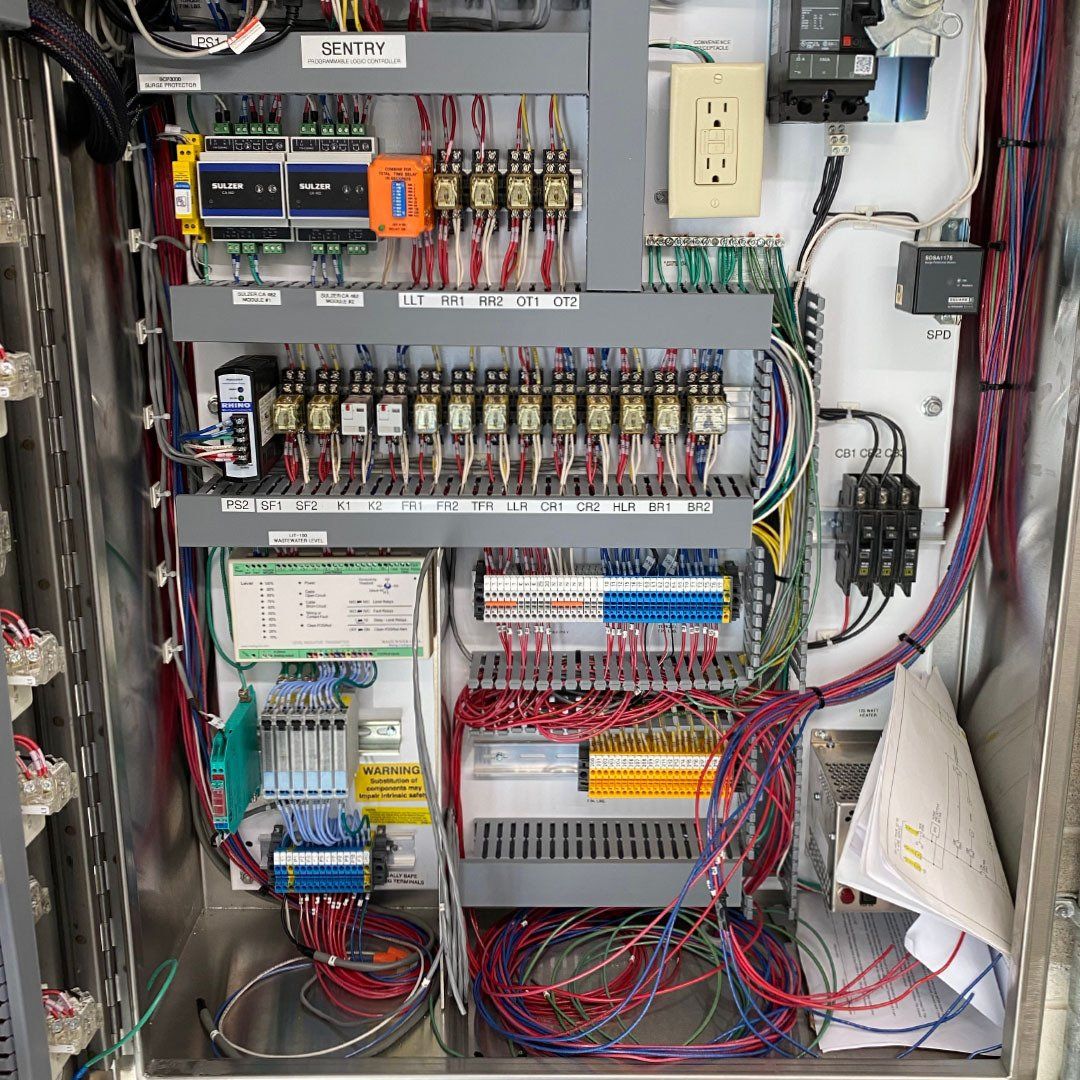 The inside of an electrical box with a lot of wires