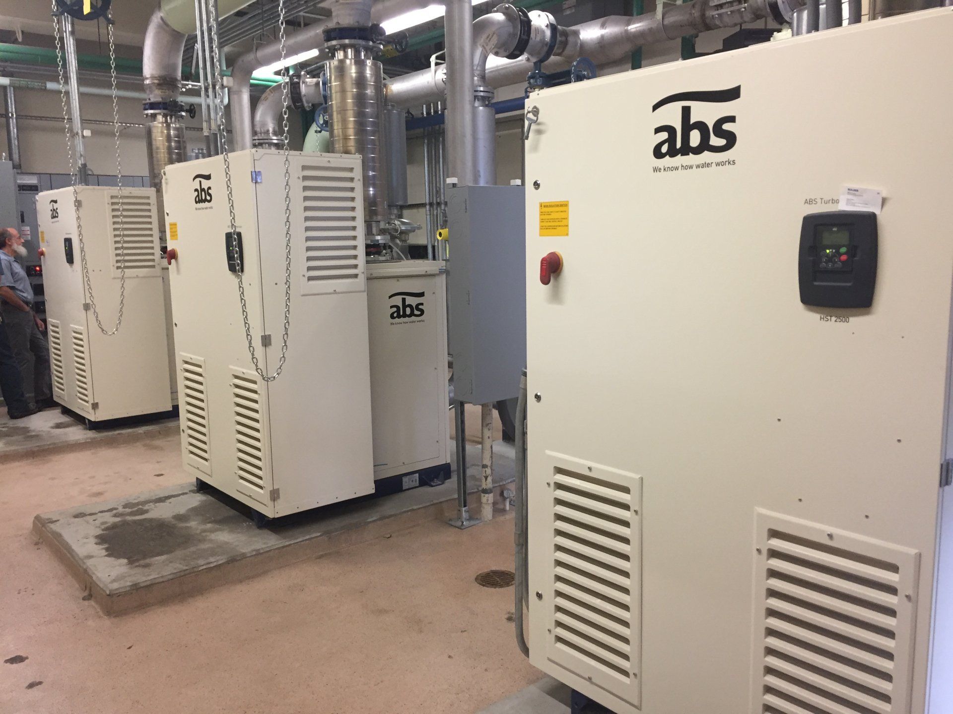 A room with a lot of electrical equipment and a box that says abs