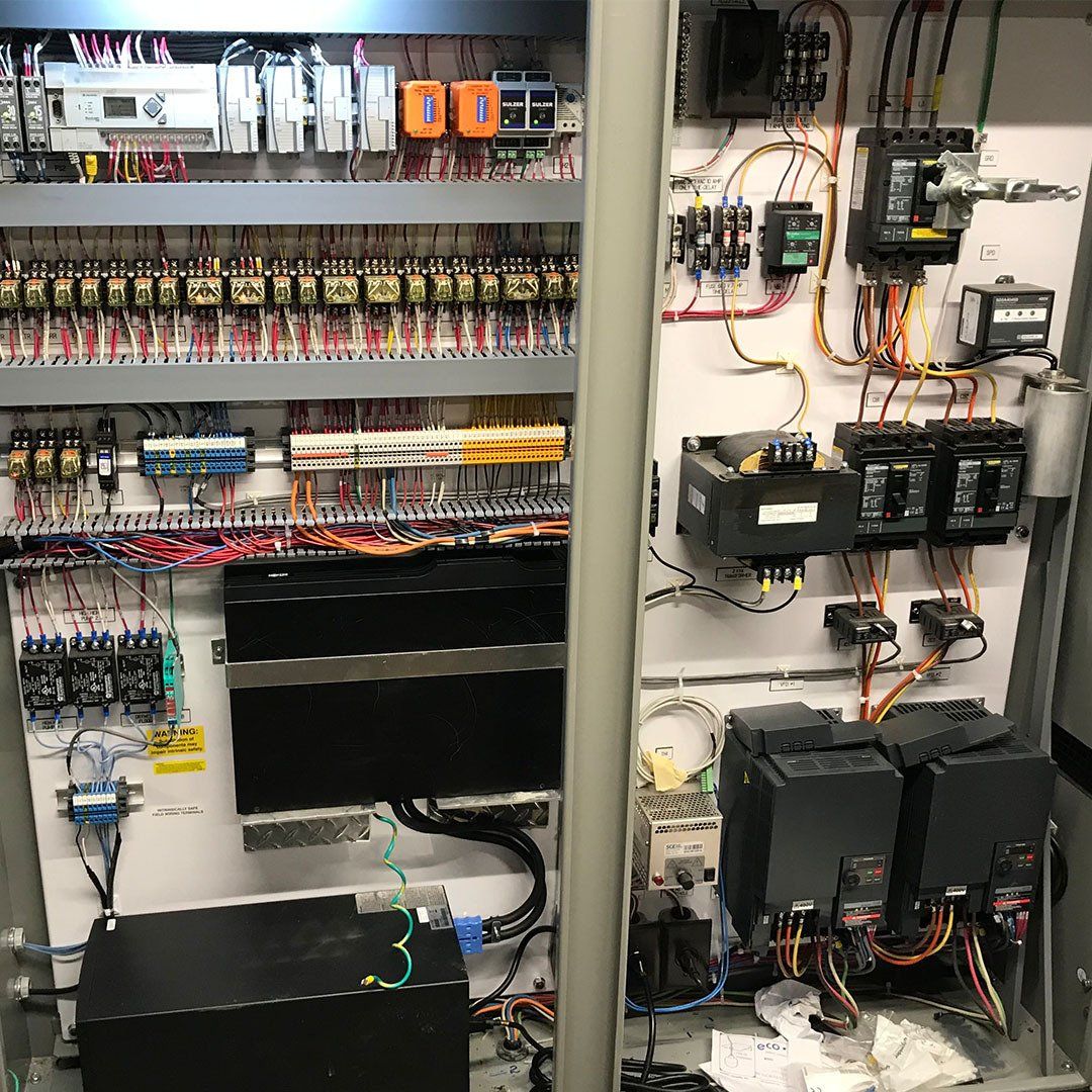A very large electrical control panel with a lot of wires coming out of it.