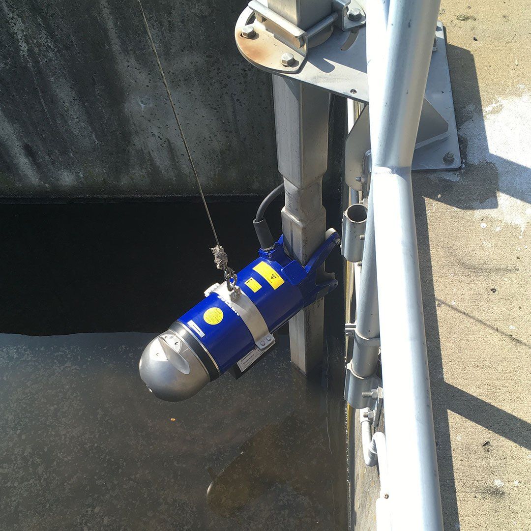 A blue and yellow device is attached to a metal pole