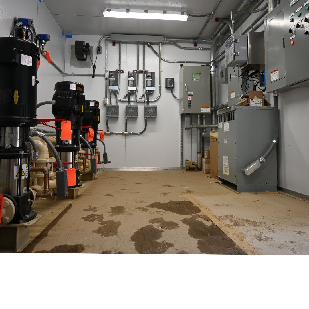 A room with a lot of electrical boxes and pumps