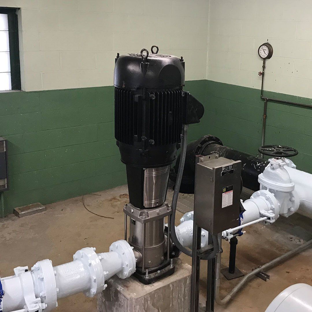 A room with a lot of pipes and a clock on the wall
