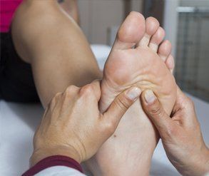 examining the sole of a foot
