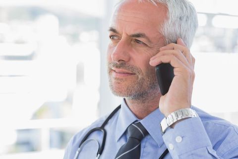 Male doctor making a mobile call.
