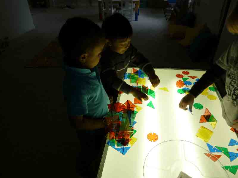 Kids playing puzzle on the table - Preschool in Beaverton, OR