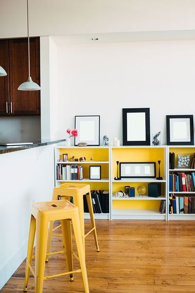 Living/dining room of a modern loft apartment. Blank frames on bookcase can be used to input your own art.