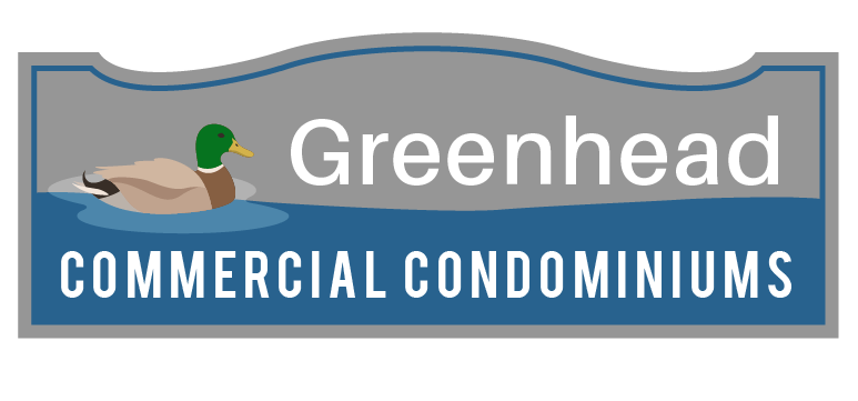 A sign for greenhead commercial condominiums with a duck on it.