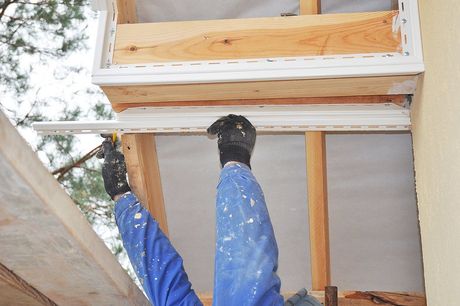 someone lifting the plastic edge siding