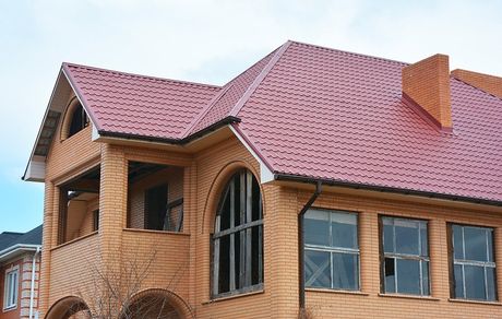 brick type house with red roof