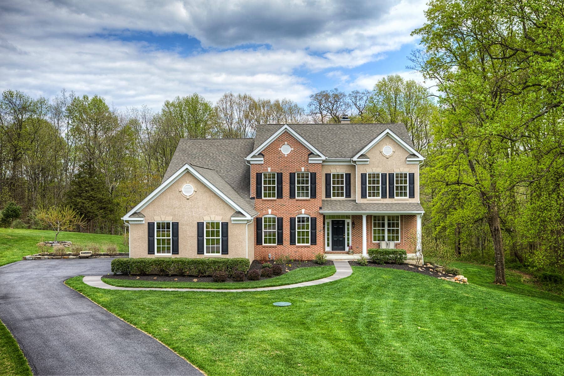 Large, two-story home with blue shutters