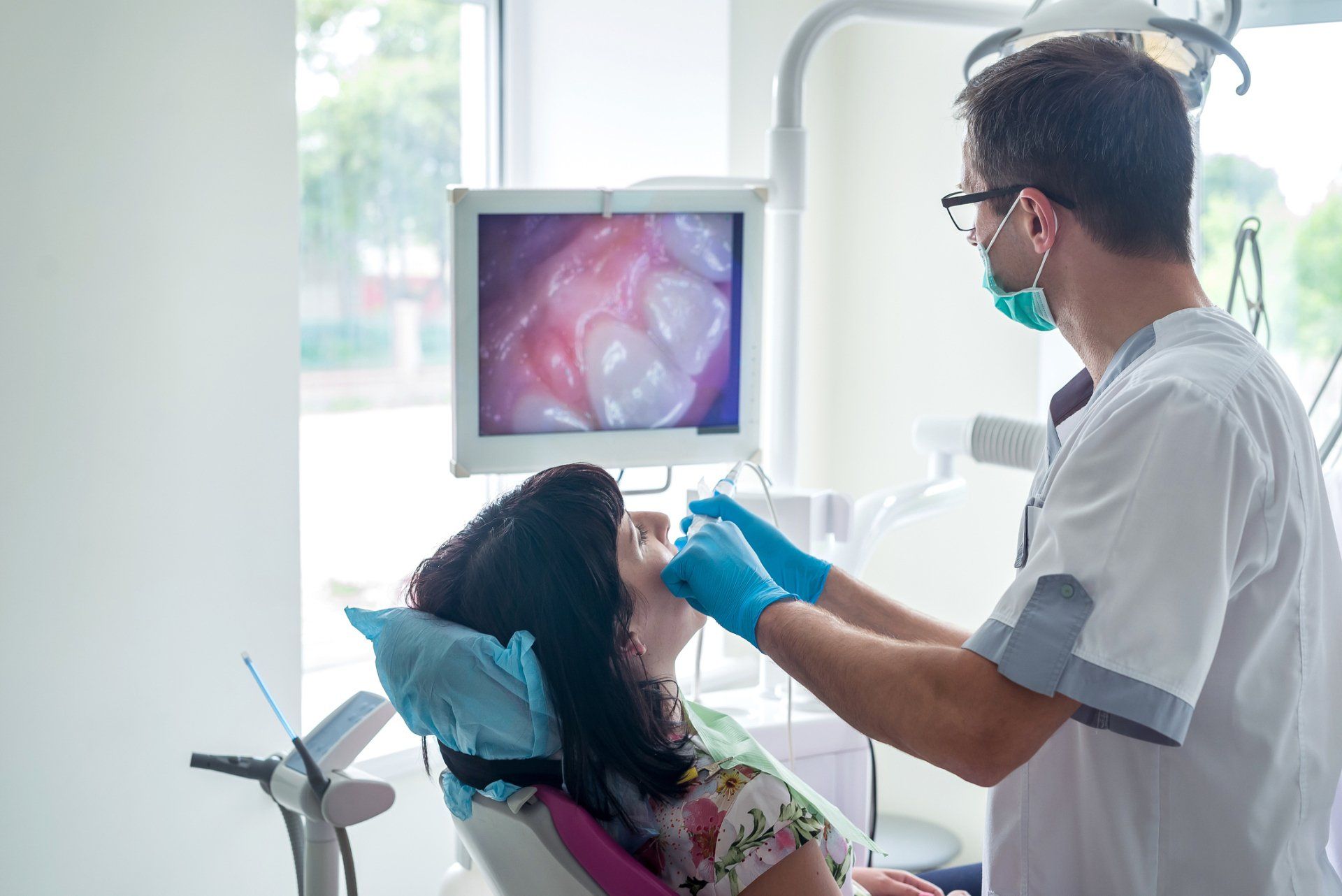 Dentist Examining Patient Teeth — Asheville, NC — Asheville Aesthetic Dental Partners