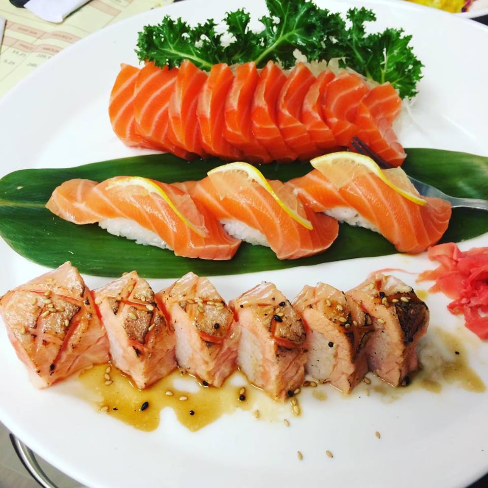 Salmon sashimi and grilled sushi roll served with citrus sauce