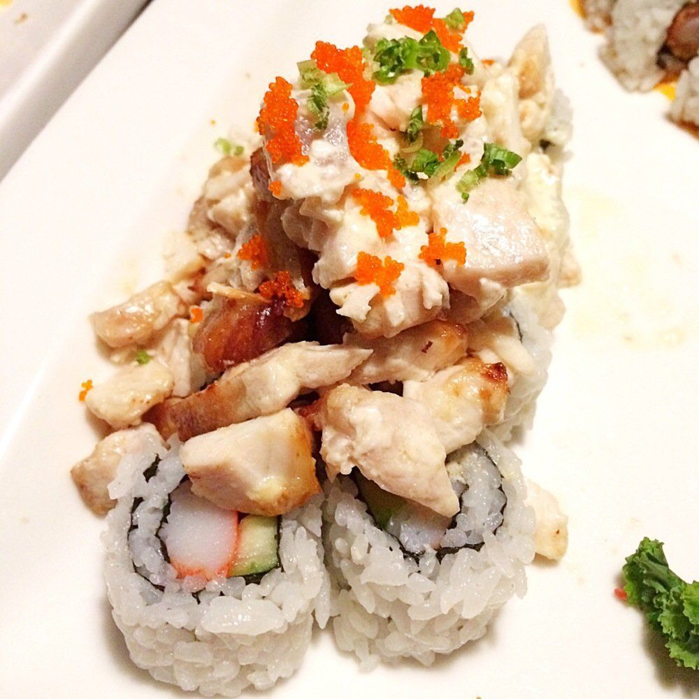 Sushi roll topped with grilled chicken and shrimp
