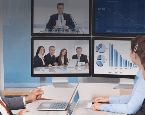 a meeting being conducted over video screens
